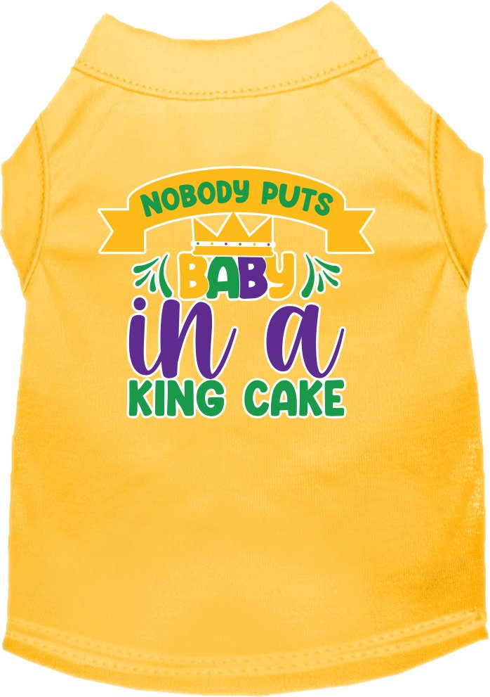A small to medium pet wearing a soft, screen printed shirt with the phrase 'Nobody Puts Baby In A King Cake', showcasing its unique design and comfortable fit.