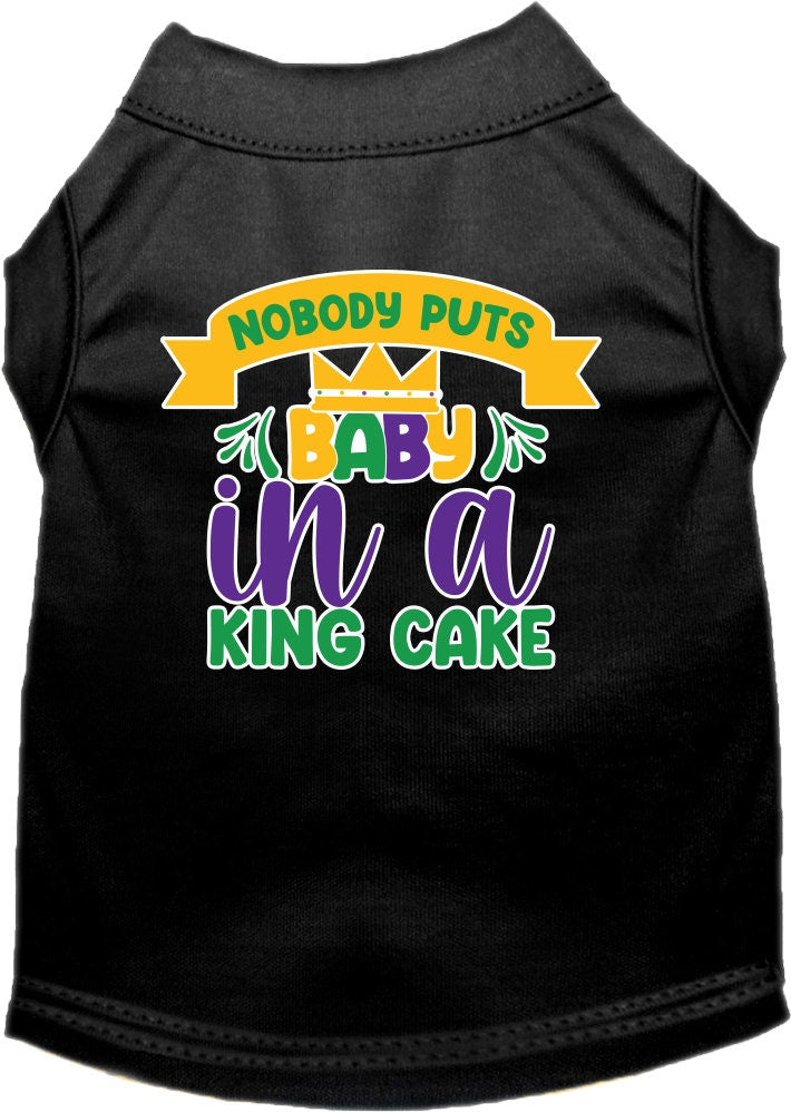 A small to medium pet wearing a soft, screen printed shirt with the phrase 'Nobody Puts Baby In A King Cake', showcasing its unique design and comfortable fit.