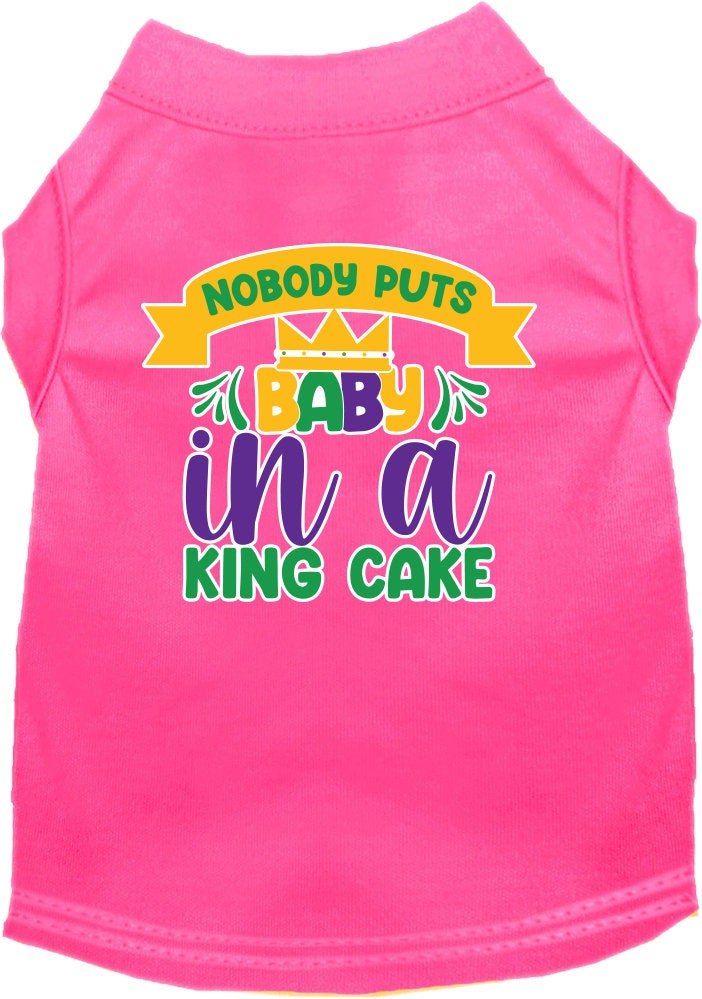 A small to medium pet wearing a soft, screen printed shirt with the phrase 'Nobody Puts Baby In A King Cake', showcasing its unique design and comfortable fit.