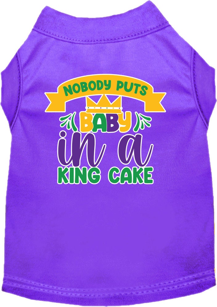 A small to medium pet wearing a soft, screen printed shirt with the phrase 'Nobody Puts Baby In A King Cake', showcasing its unique design and comfortable fit.