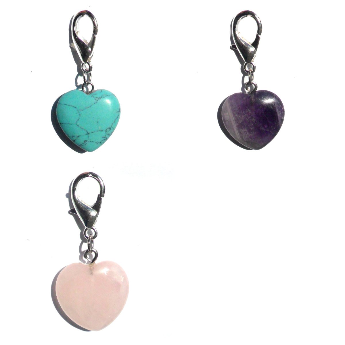 A collection of Pet Gemstone Crystal Heart Charms in Amethyst, Rose Quartz, and Turquoise, showcasing their vibrant colors and heart shape.