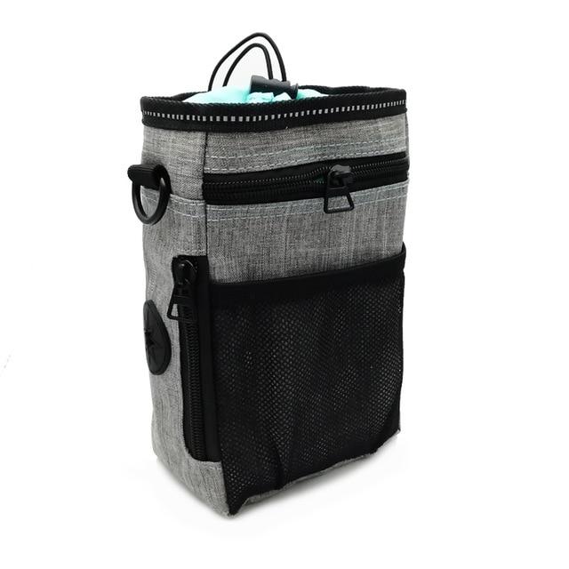Portable Dog Training Bag made of durable Oxford cloth, featuring multiple pockets for treats, snacks, and poop bags, ideal for outdoor use.