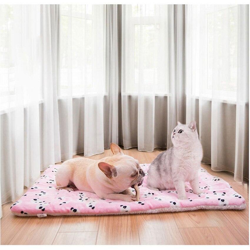 A cozy Portable Pet Dog Bed Blanket made of soft coral fleece, ideal for keeping dogs warm during winter, featuring a stylish print pattern.