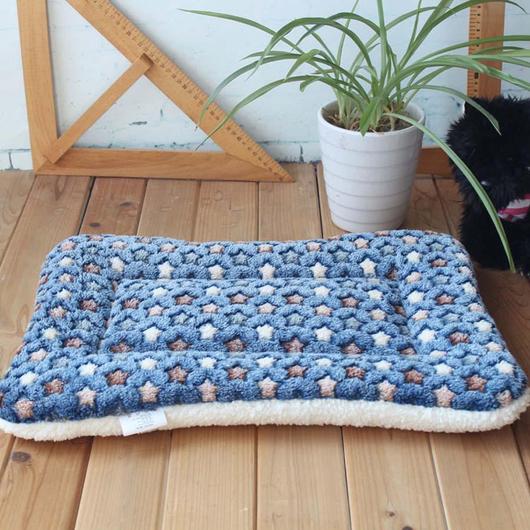 A cozy Premium Soft Fleece Cushion Blanket designed for cats, featuring a fluffy texture and warm color, perfect for cuddling.