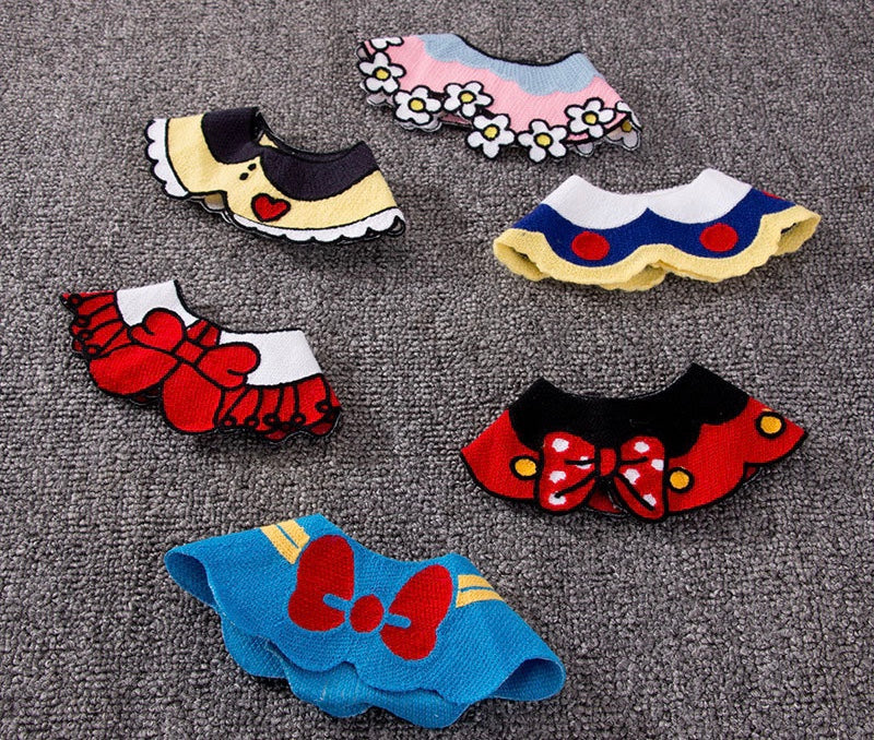 A stylish cat wearing a colorful bib outfit, showcasing its unique design and high-quality fabric.