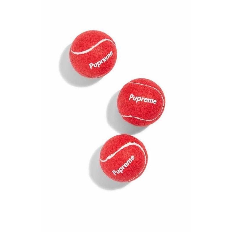 Pupreme Tennis Balls in vibrant colors, perfect for dog play and fetch, showcasing their durable polyester fiber exterior and rubber interior.