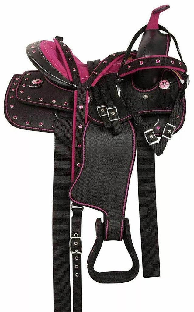 Purple synthetic western barrel racing horse saddle with matching tack accessories including headstall, breast collar, reins, and saddle pad.