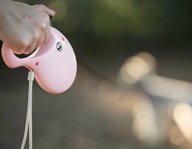 Retractable Pet Dog Leash in black, blue, and pink colors, featuring a reflective design and ergonomic handle for comfort.