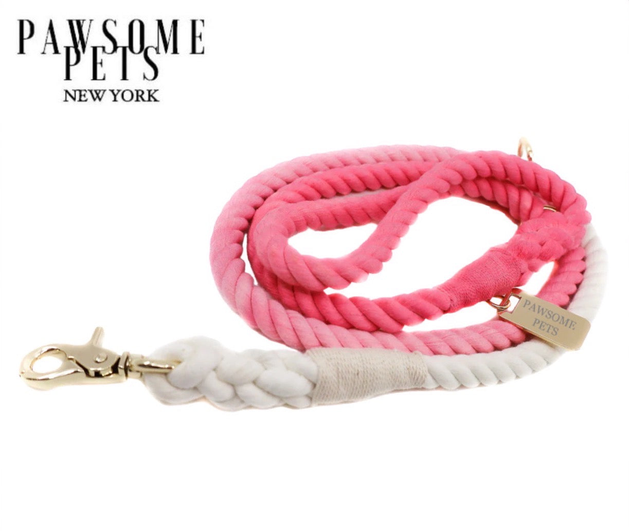 A vibrant flamingo-colored rope leash made of 100% cotton, featuring luxe hardware and a matching dog charm.