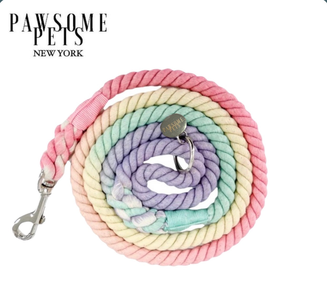 A colorful light rainbow rope leash made of cotton, featuring luxe hardware and a matching dog charm, perfect for stylish pet walks.