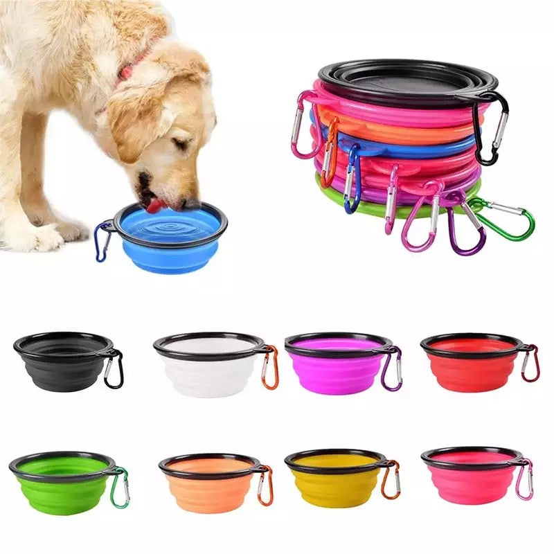 Silicone dog feeder bowl in vibrant color, featuring a carabiner for easy attachment, ideal for travel and outdoor use.