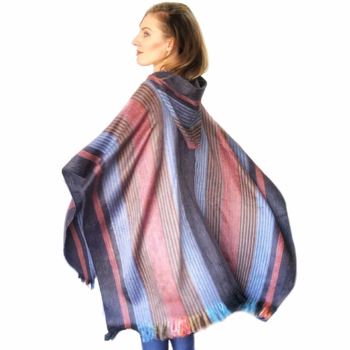 A beautifully crafted Six Band Alpaca Poncho showcasing intricate patterns of colored bands, made from 80% alpaca wool.