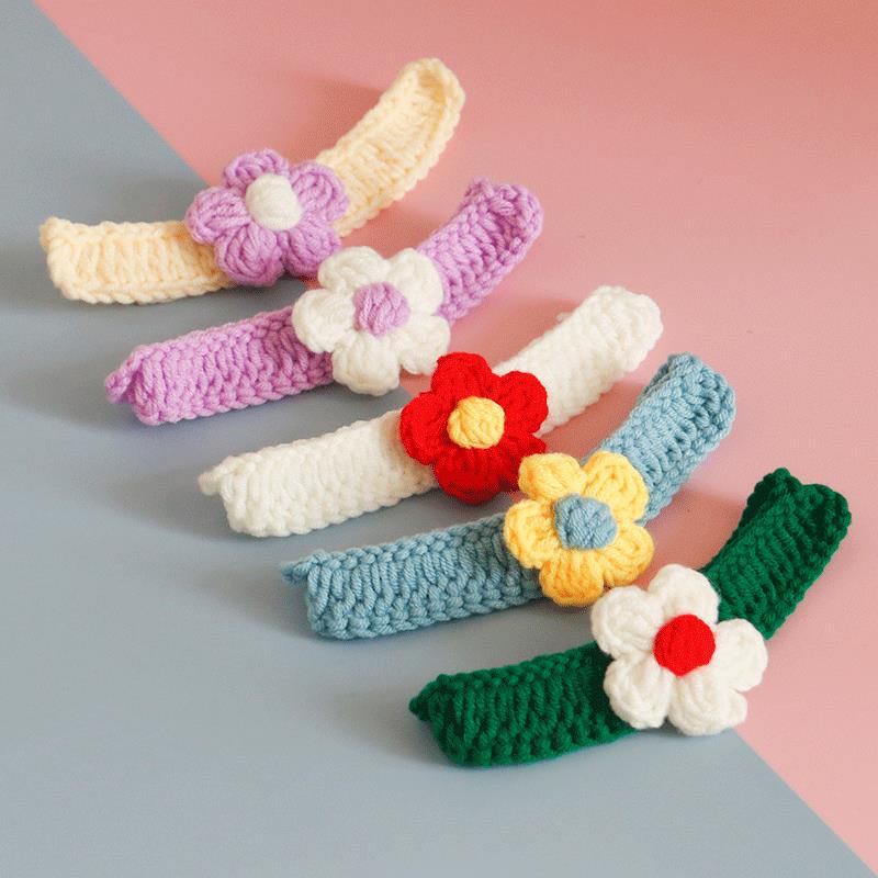 A collection of small floral handmade collars for pets, showcasing vibrant colors and intricate crochet designs.