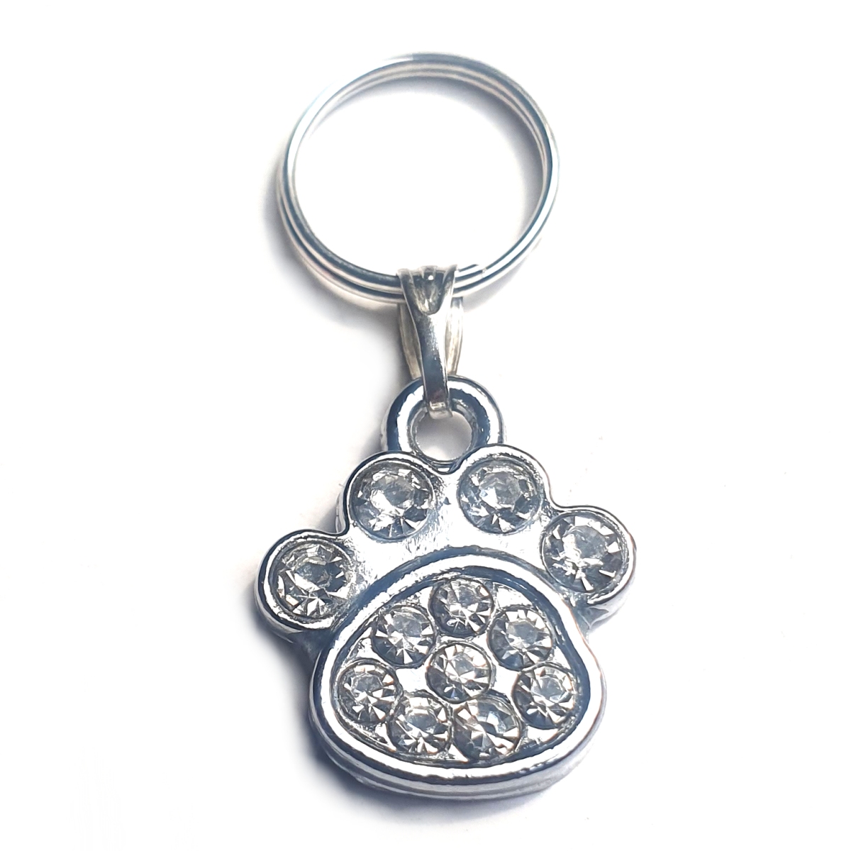 Small rhinestone paw charms for dogs and cats, featuring clear sparkling rhinestones and a lobster clasp for easy attachment.