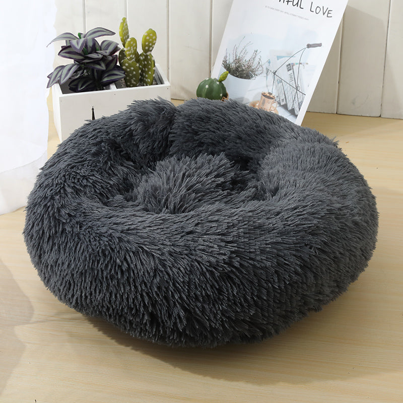 Soft Calming Donut Bed for Dogs and Cats, featuring a plush, fluffy design with raised edges for comfort and security.