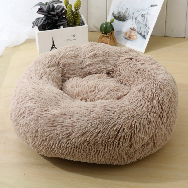 Soft Calming Donut Bed for Dogs and Cats, featuring a plush, fluffy design with raised edges for comfort and security.