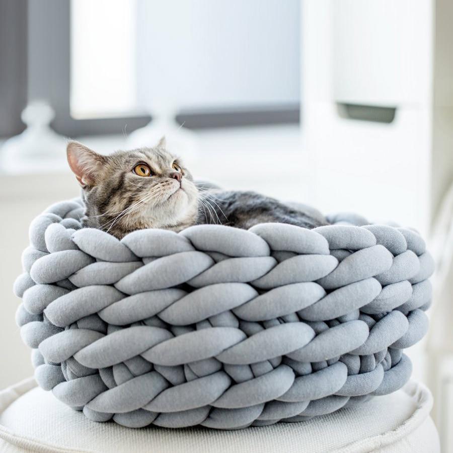 A cozy, handmade knit pet bed designed for small dogs and cats, featuring a soft, breathable fabric and a detachable design for easy washing.