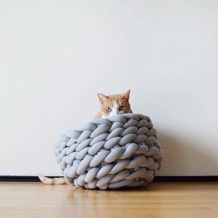 A cozy, handmade knit pet bed designed for small dogs and cats, featuring a soft, breathable fabric and a detachable design for easy washing.