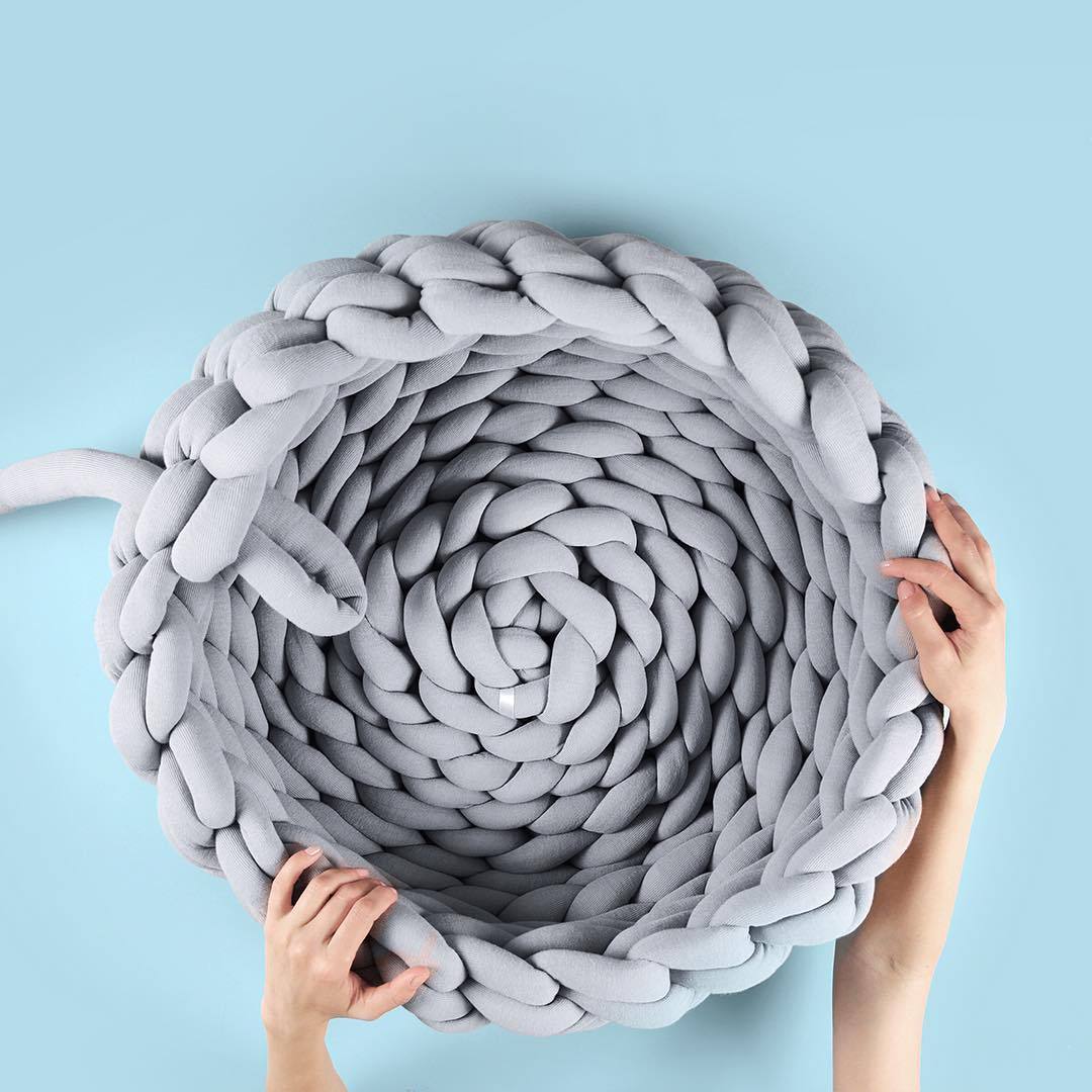 A cozy, handmade knit pet bed designed for small dogs and cats, featuring a soft, breathable fabric and a detachable design for easy washing.