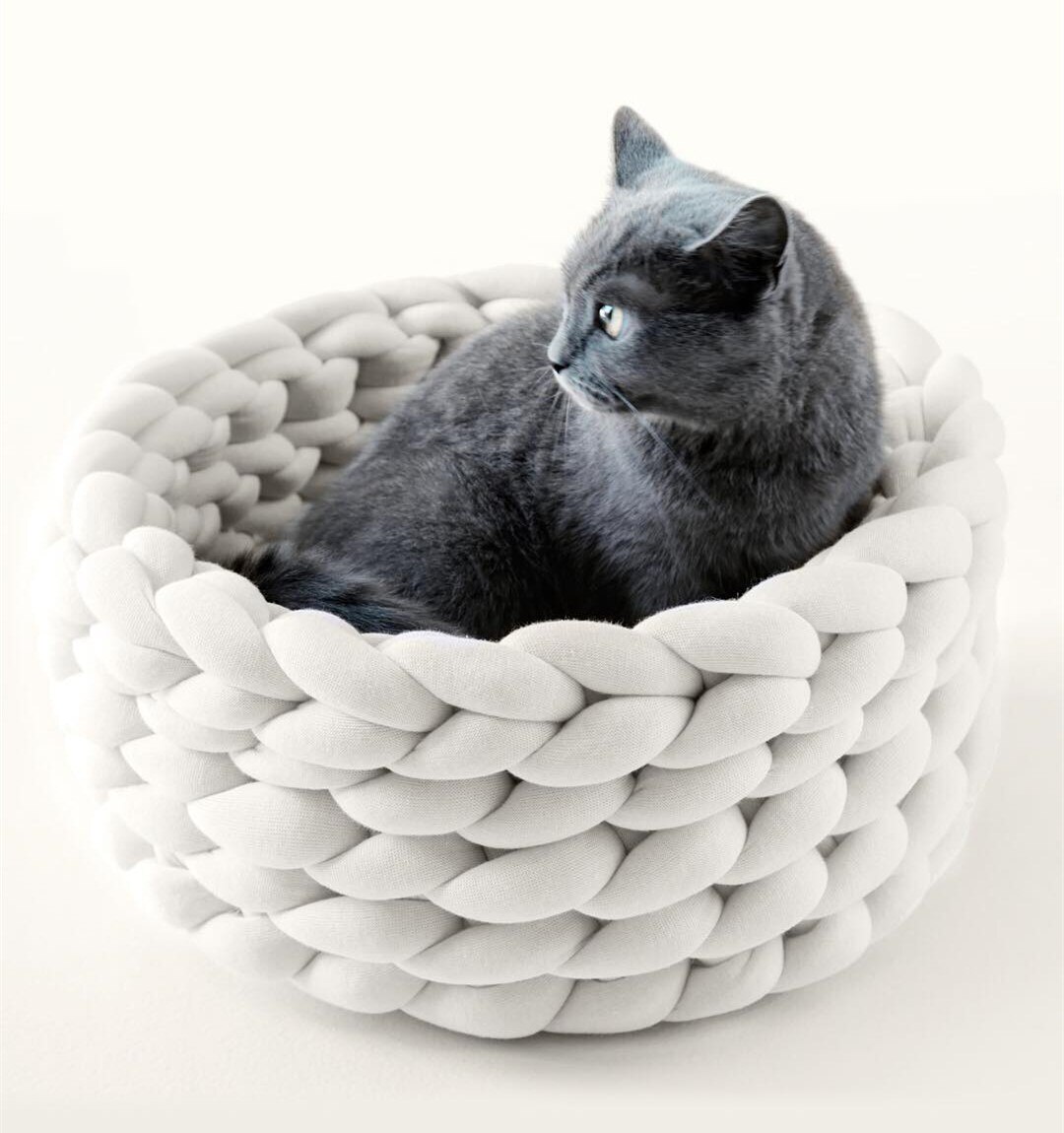 A cozy, handmade knit pet bed designed for small dogs and cats, featuring a soft, breathable fabric and a detachable design for easy washing.