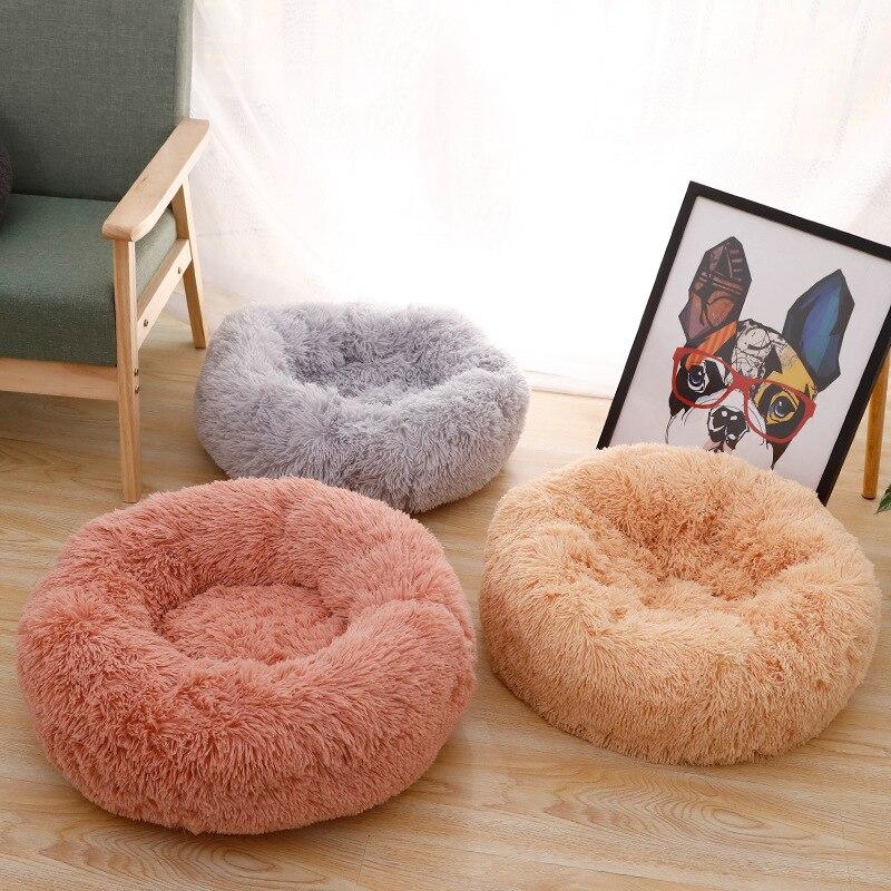 A soft, round dog bed made of plush coral fleece, designed for winter comfort, suitable for small and large dogs and cats.