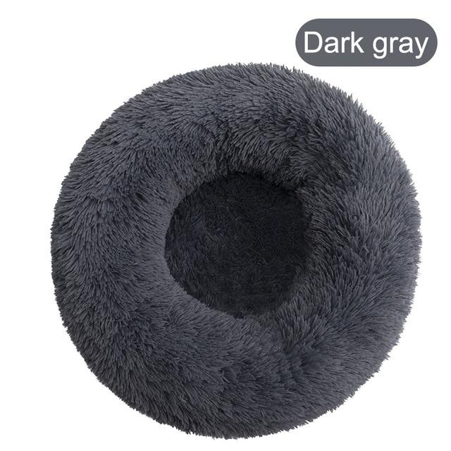 A soft, round dog bed made of plush coral fleece, designed for winter comfort, suitable for small and large dogs and cats.