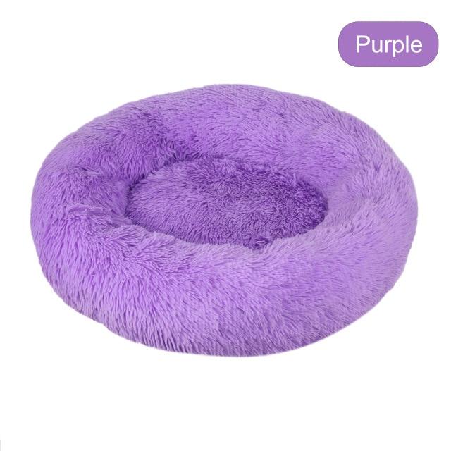 A soft, round dog bed made of plush coral fleece, designed for winter comfort, suitable for small and large dogs and cats.