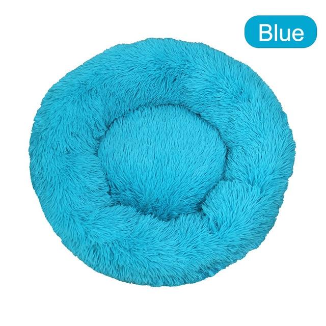A soft, round dog bed made of plush coral fleece, designed for winter comfort, suitable for small and large dogs and cats.