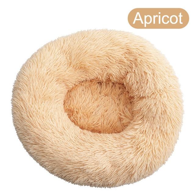 A soft, round dog bed made of plush coral fleece, designed for winter comfort, suitable for small and large dogs and cats.