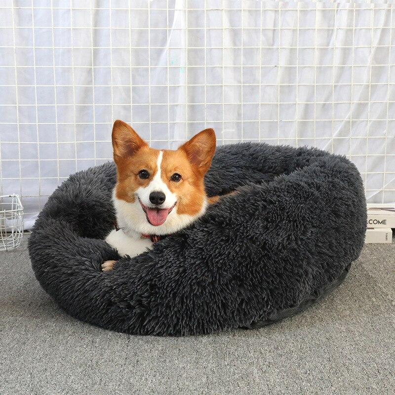 A soft, round dog bed made of plush coral fleece, designed for winter comfort, suitable for small and large dogs and cats.