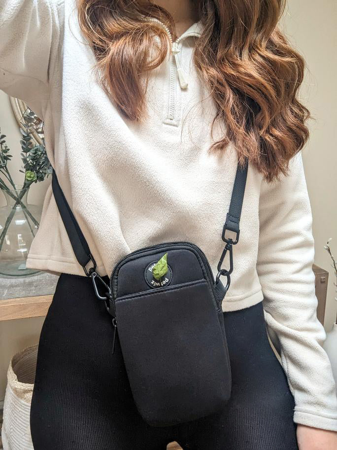 A stylish and functional lightweight dog walking bag with zipped compartments and adjustable strap, perfect for dog owners.