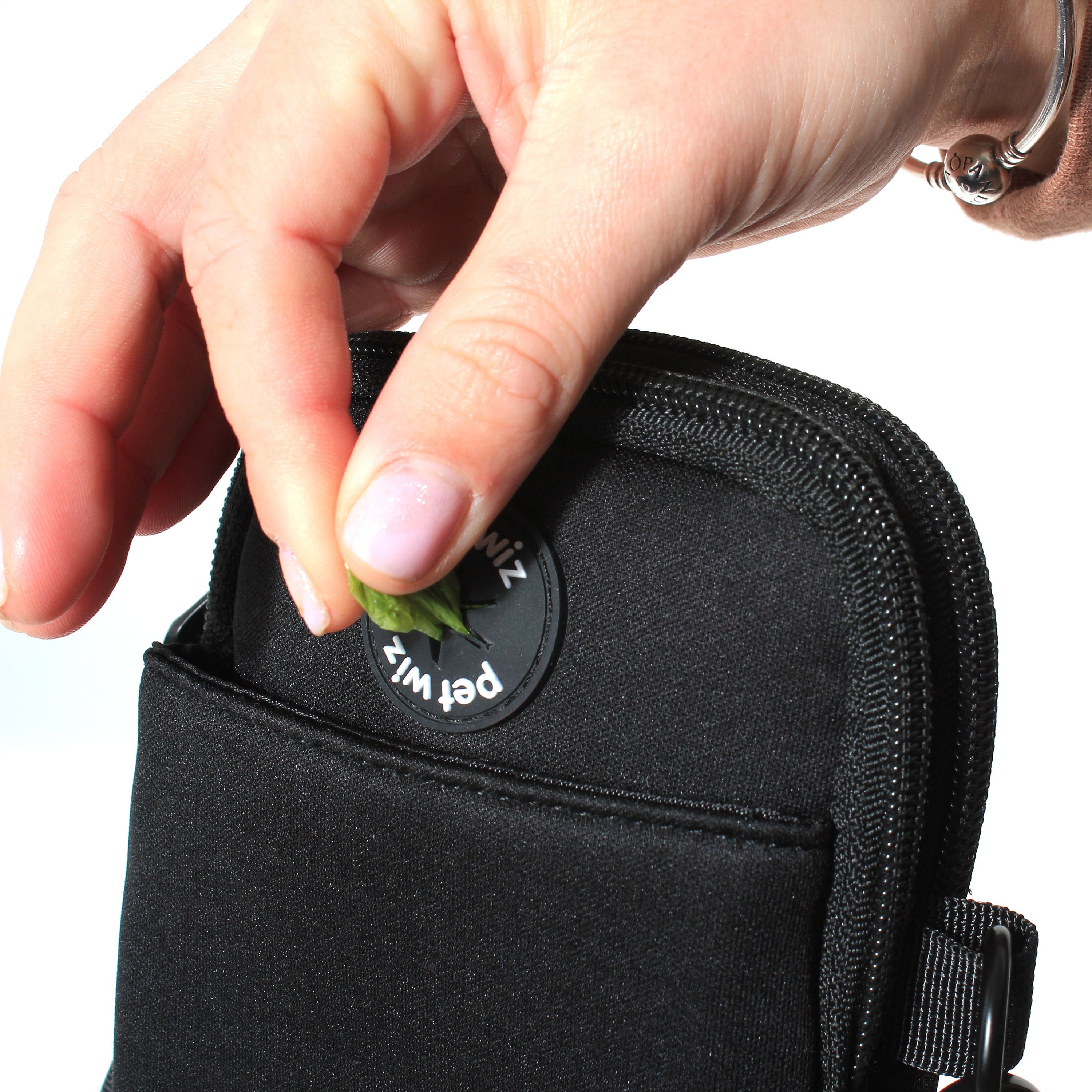 A stylish and functional lightweight dog walking bag with zipped compartments and adjustable strap, perfect for dog owners.