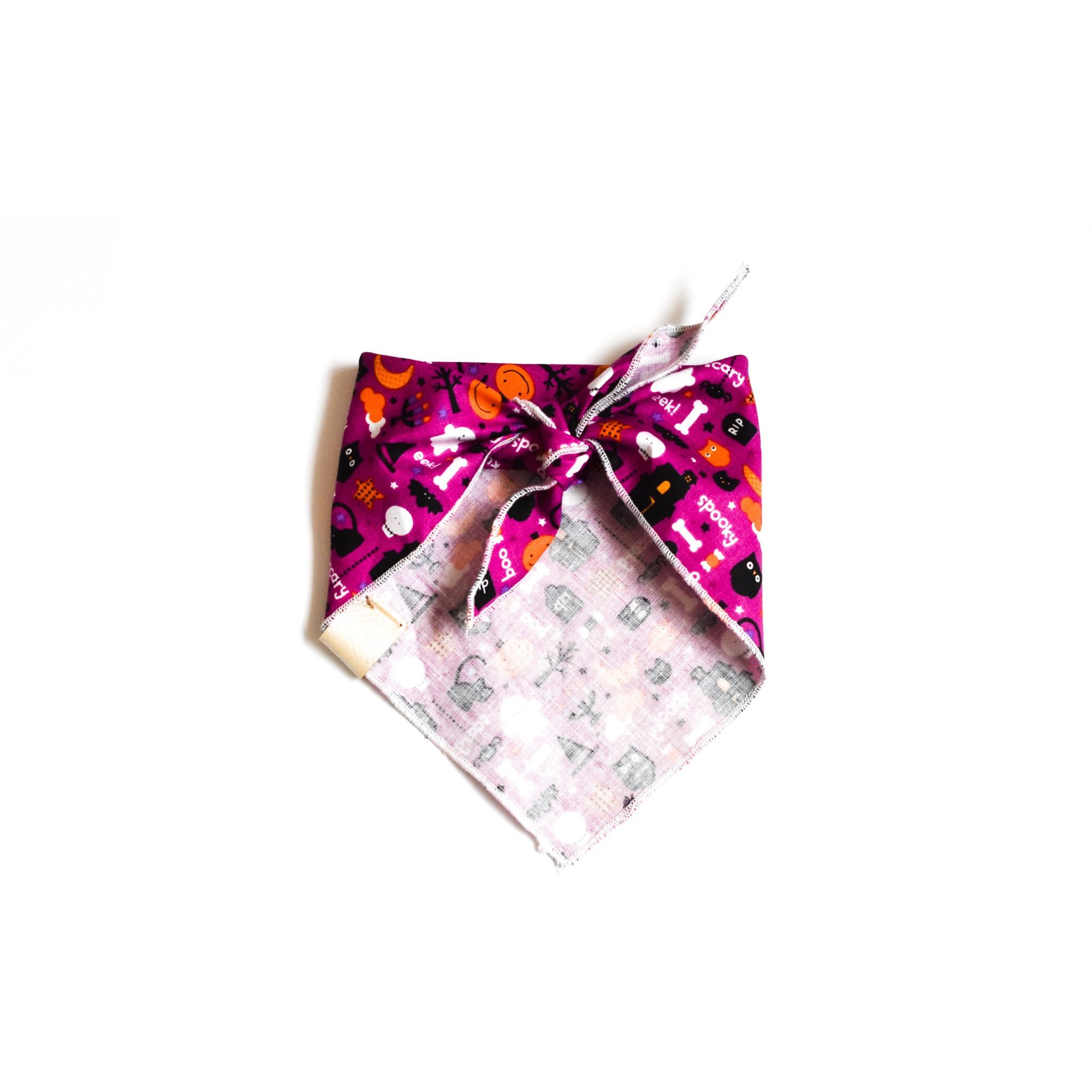 Spooks Galore dog bandana featuring Halloween-themed cotton fabric and a vegan leather tag, perfect for festive occasions.