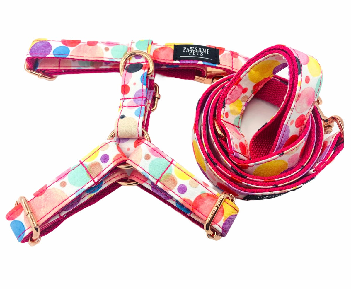 Two colorful pet harnesses from the STEP IN BUNDLE - OH MY BUBBLES, showcasing durable fabric and adjustable straps.