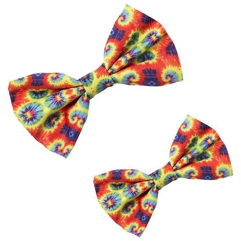 A colorful tie-dye bowtie for dogs, featuring vibrant reds, blues, yellows, and greens, made from soft polyester and adjustable for any collar size.