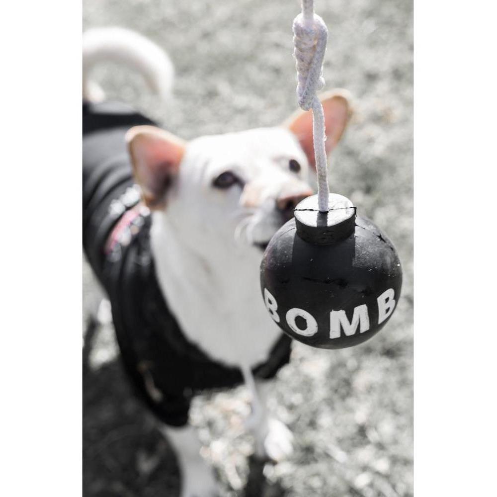 Tuff Bomb dog toy made from 100% pure New Rubber, featuring a rugged design and attached rope for fetching.
