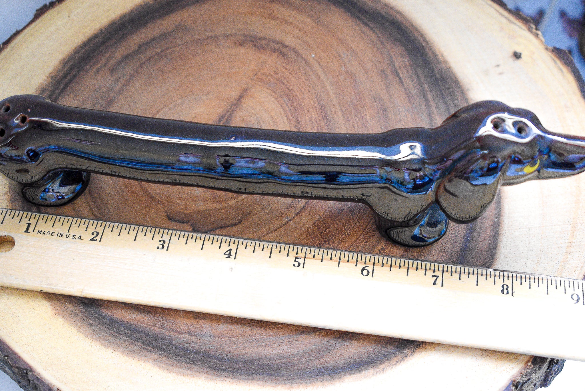 A beautifully crafted vintage porcelain dachshund figurine, measuring approximately 8 x 3 inches, showcasing intricate details and a charming design.