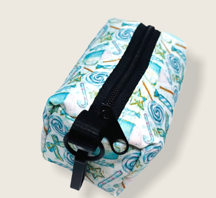 WASTE BAG HOLDER-Lollipop made of heavyweight neoprene, featuring a black clasp and a small zipper pull, designed for easy waste management.