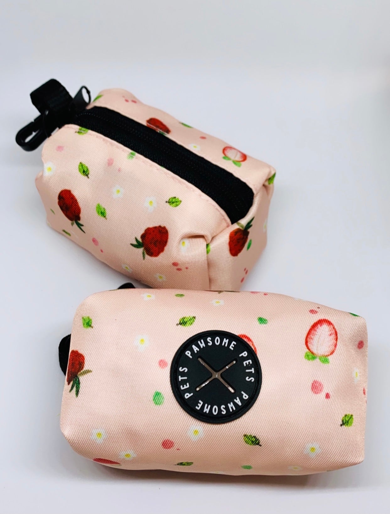 Stylish strawberry-themed waste bag holder made of heavyweight neoprene, featuring a black clasp and compact design.