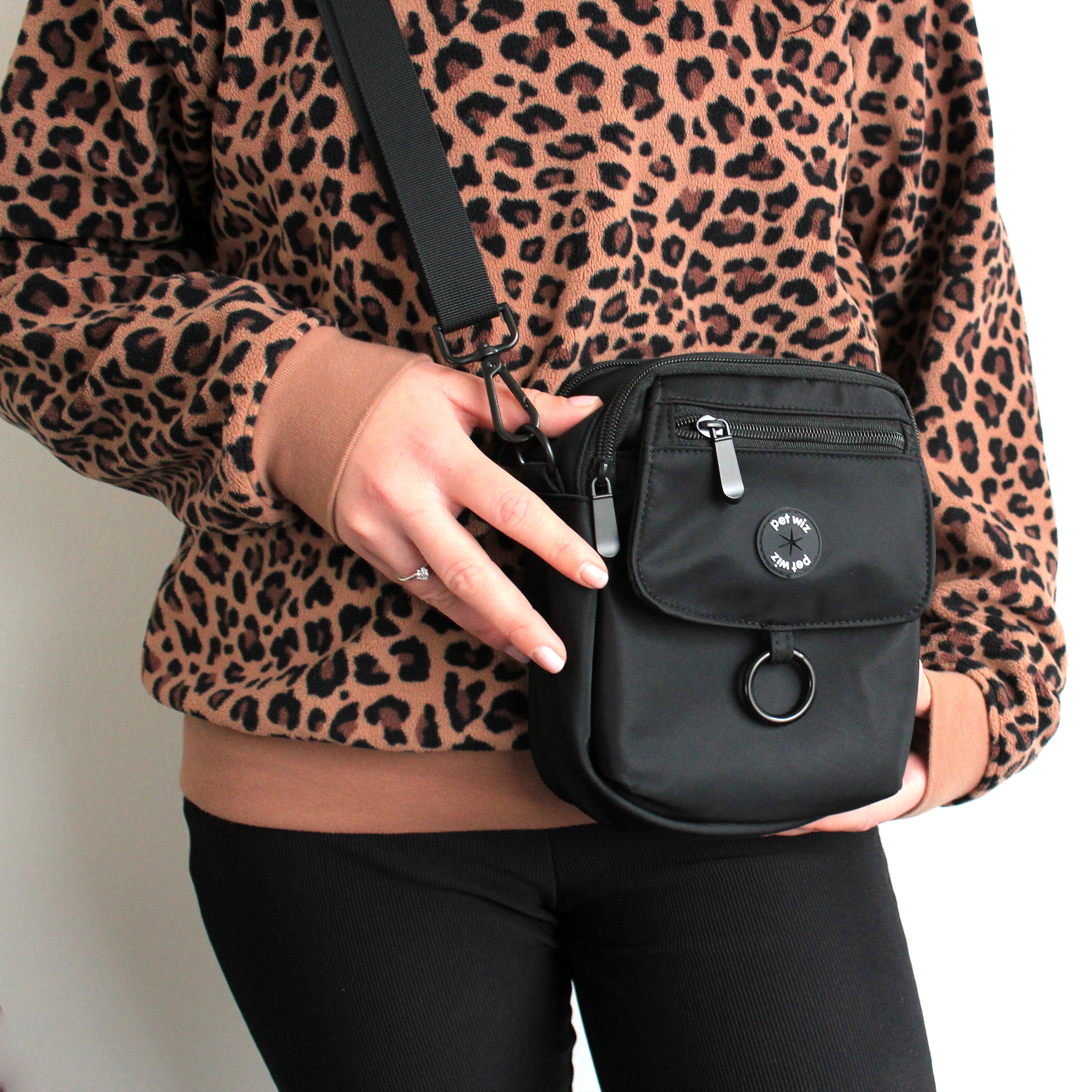 A stylish waterproof dog walking bag with multiple compartments, designed for pet owners to keep essentials organized during walks.