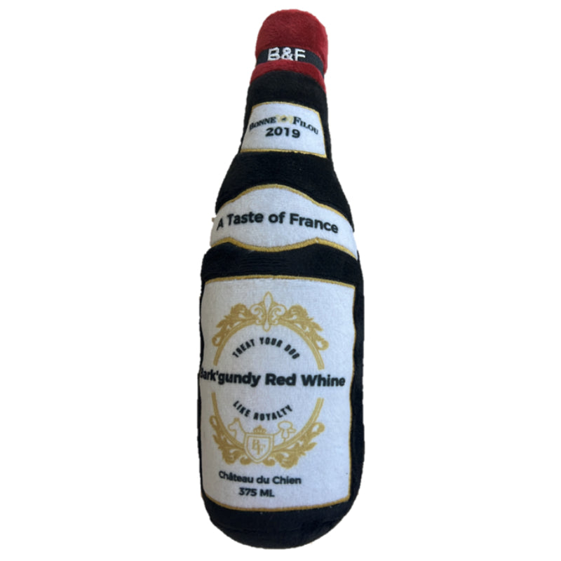 A plush dog toy shaped like a wine bottle in Bark'gundy color, featuring a squeaker and made from soft recycled materials.