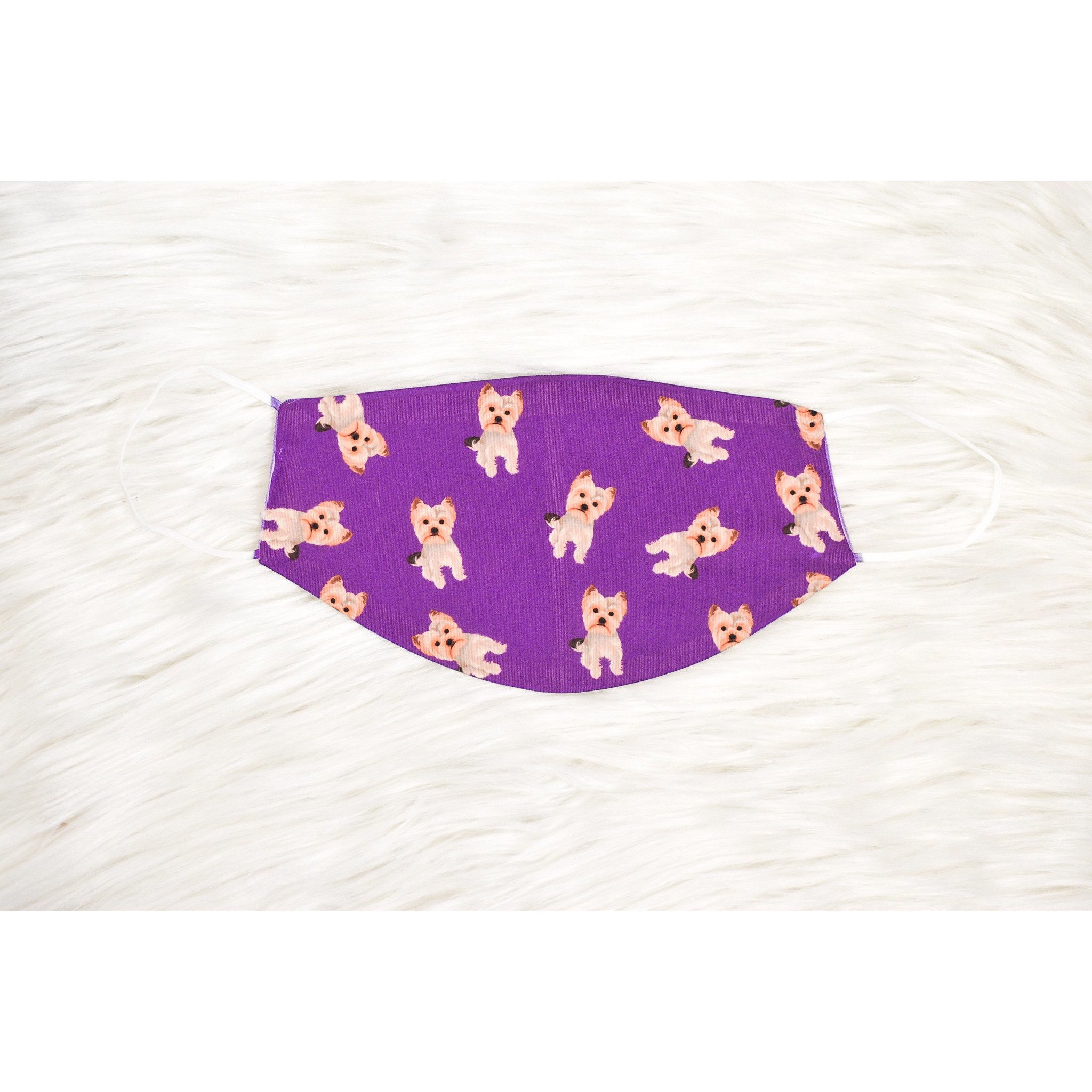 A handmade Yorkie face cover featuring a soft organic cotton interior and durable polyester exterior, available in various sizes.