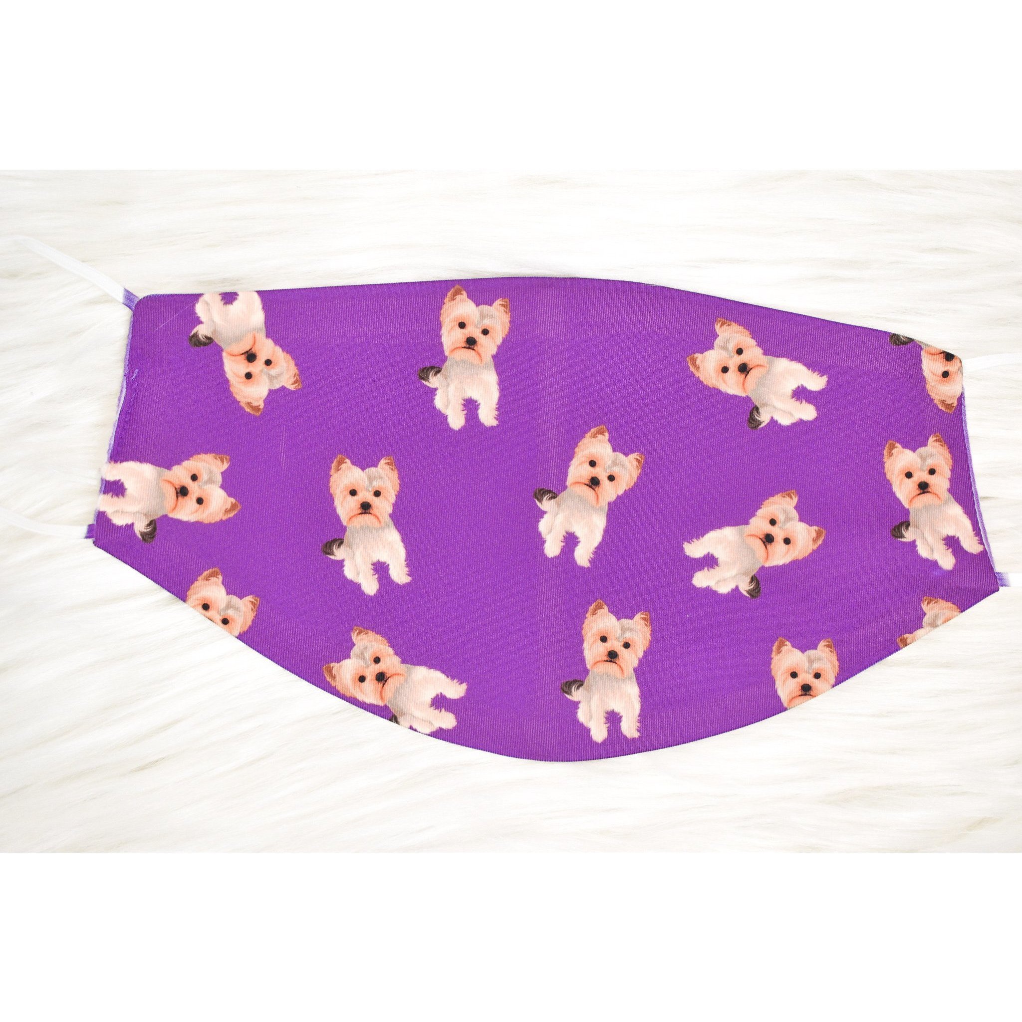 A handmade Yorkie face cover featuring a soft organic cotton interior and durable polyester exterior, available in various sizes.