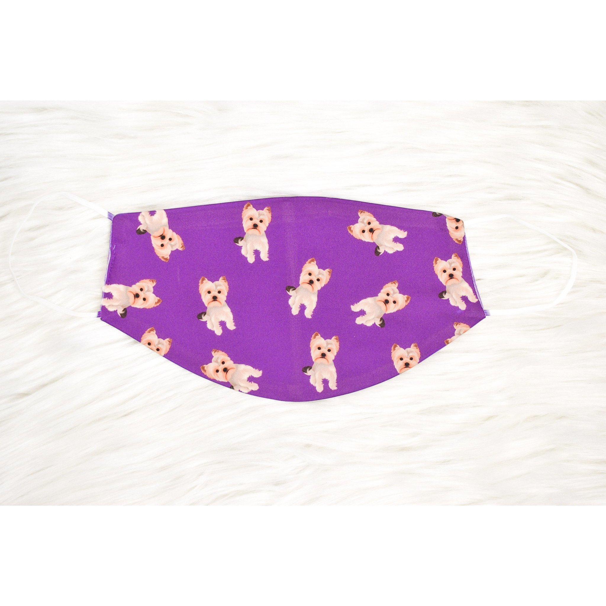 A handmade Yorkie face cover featuring a soft organic cotton interior and durable polyester exterior, available in various sizes.