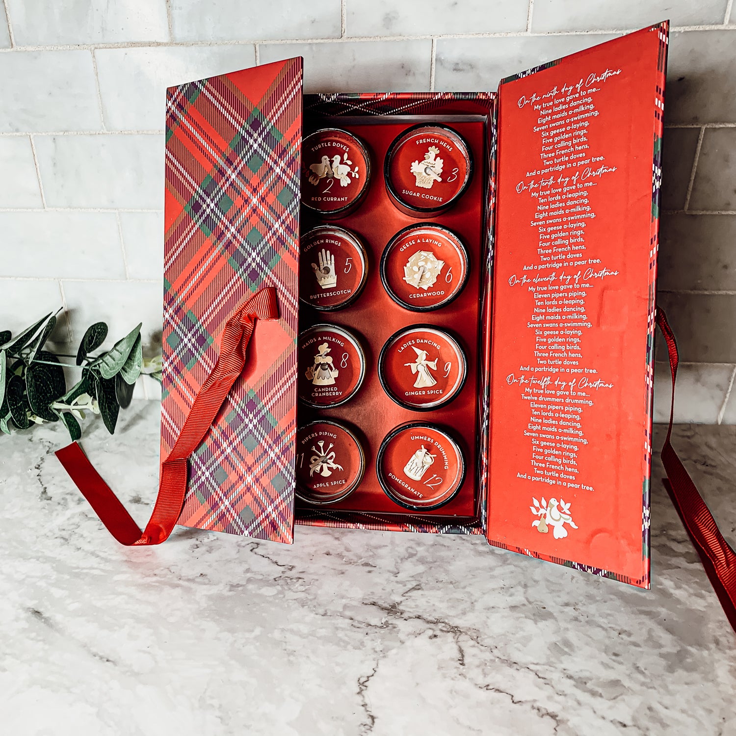 Advent Candle Set featuring 12 scented candles in a festive gift box with Silver, Gold, and Red colors.