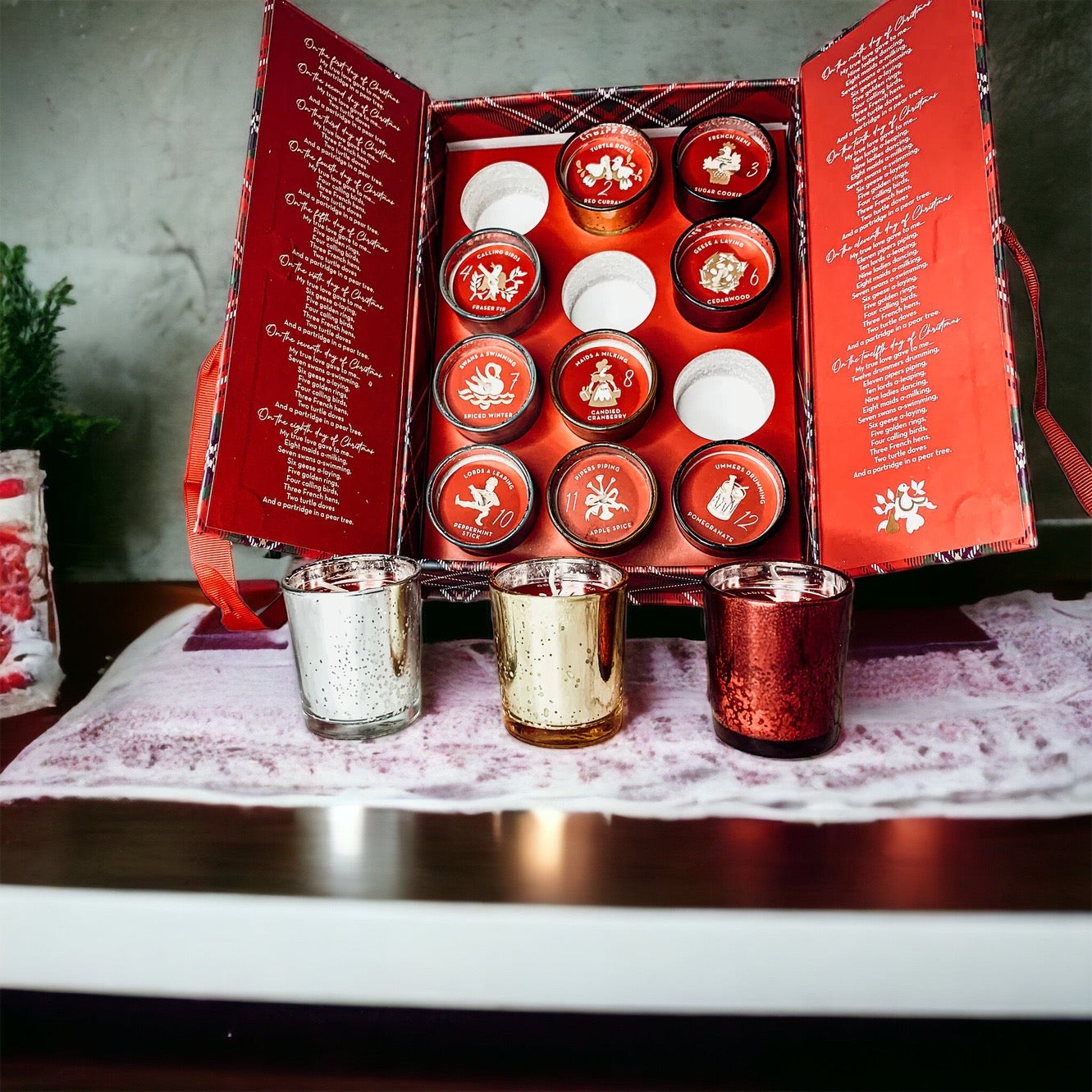Advent Candle Set featuring 12 scented candles in a festive gift box with Silver, Gold, and Red colors.