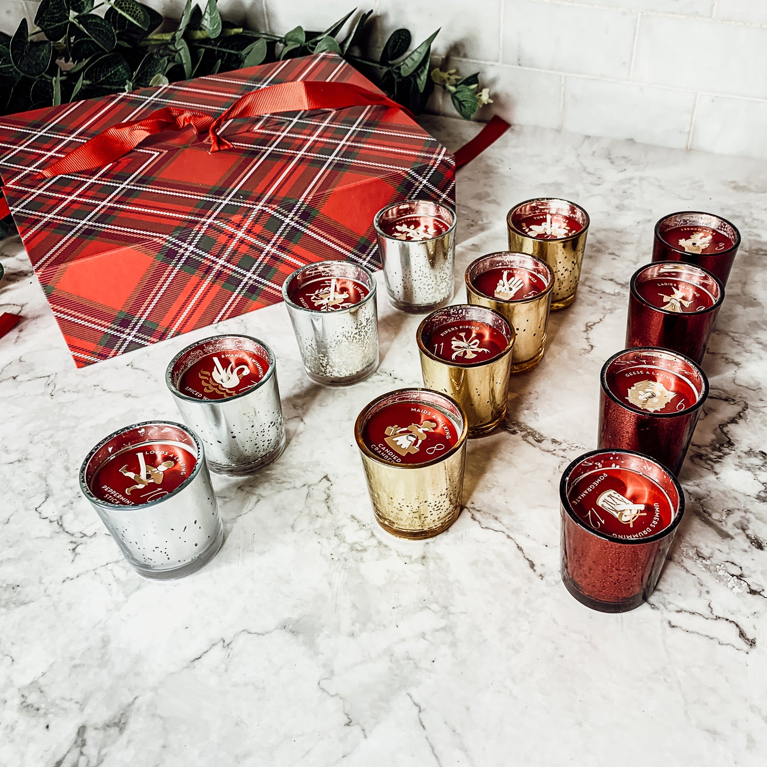 Advent Candle Set featuring 12 scented candles in a festive gift box with Silver, Gold, and Red colors.