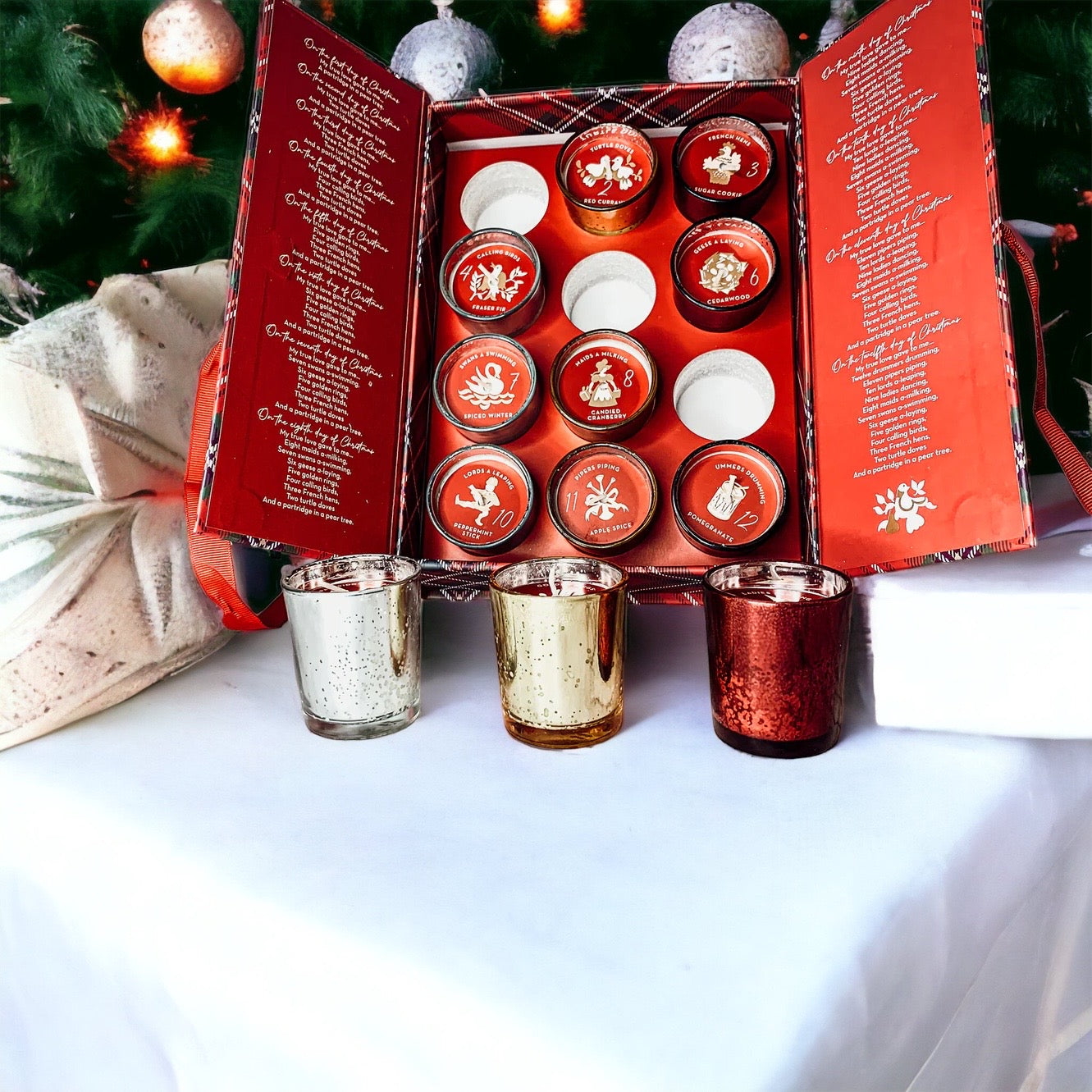 Advent Candle Set featuring 12 scented candles in a festive gift box with Silver, Gold, and Red colors.
