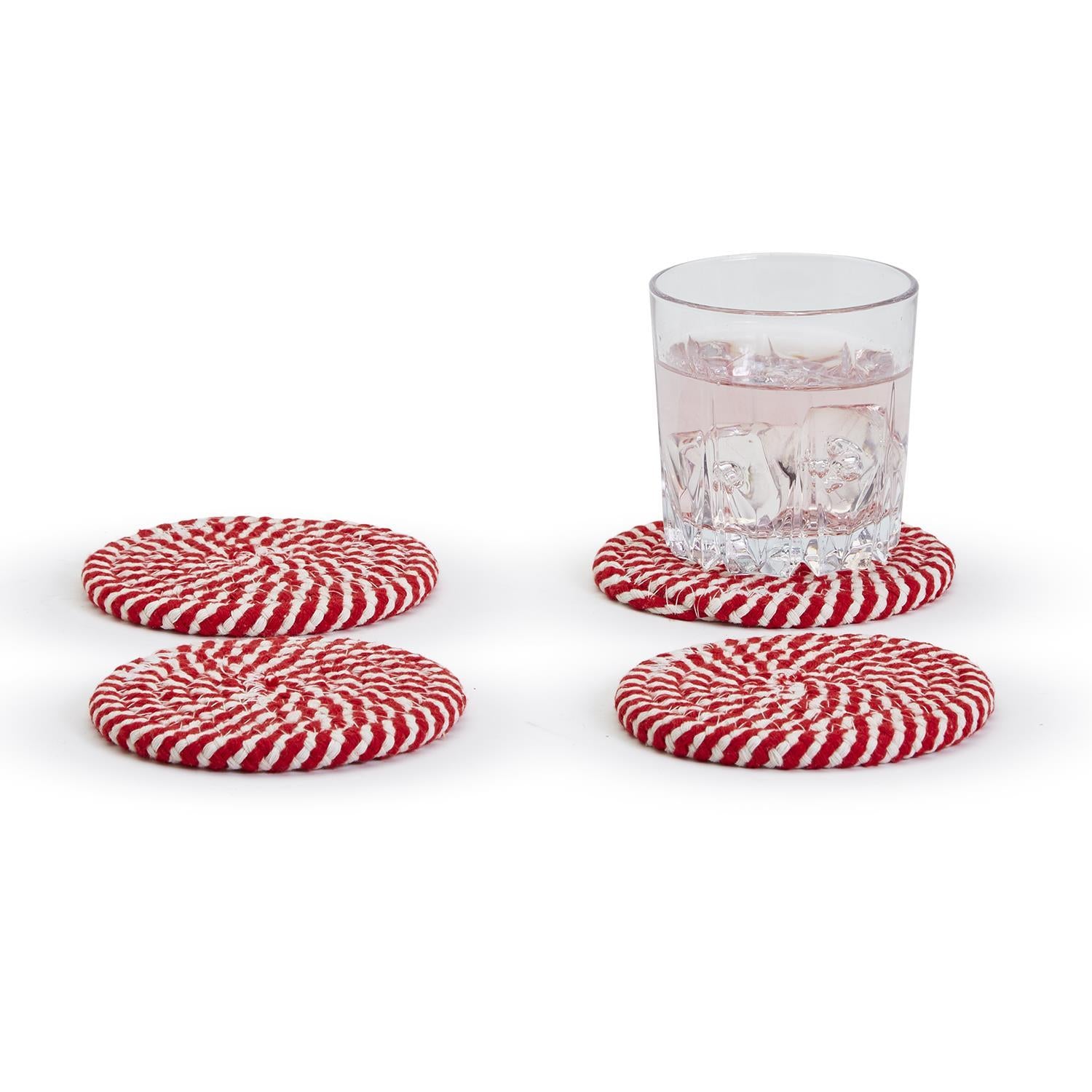 A set of four candy cane striped coasters with braided detail, perfect for holiday decor.