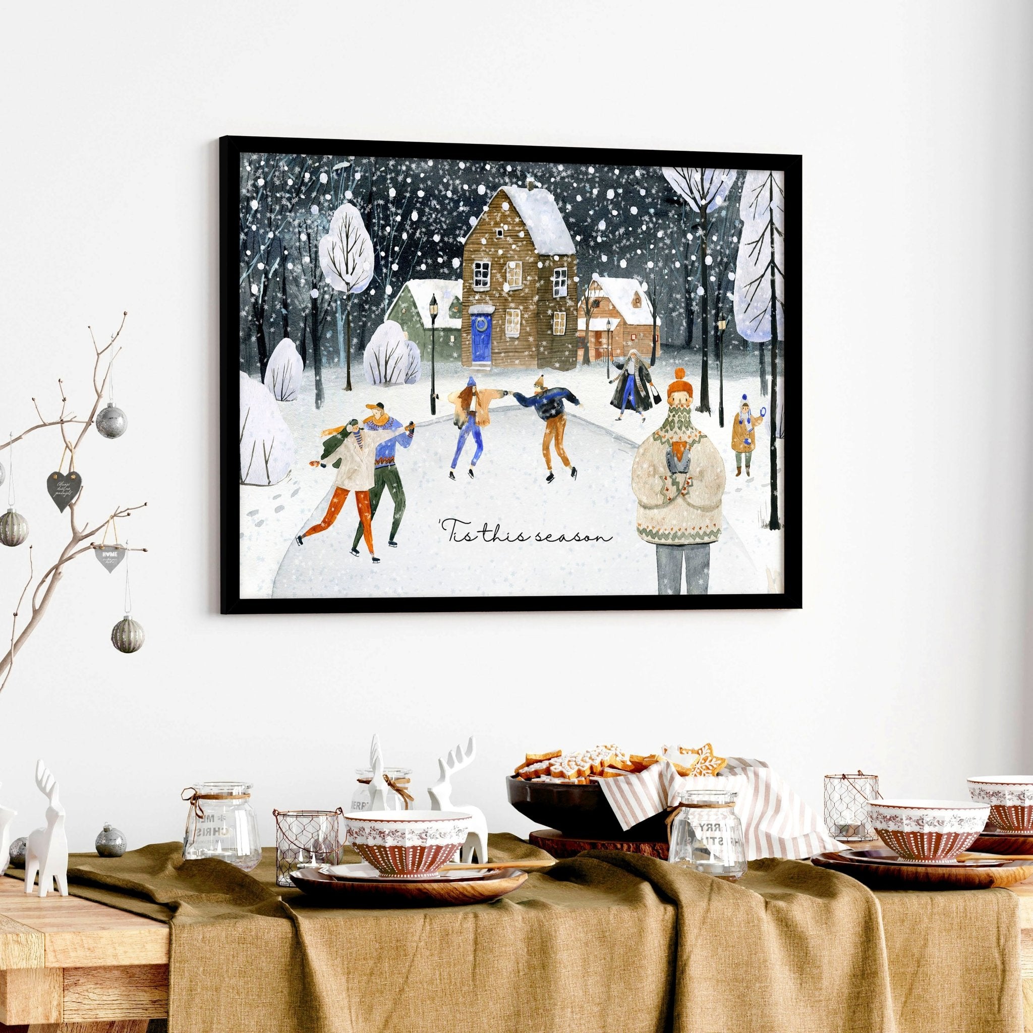 A beautiful watercolour Christmas wall art print depicting a snowy village scene with people skating and decorated pine trees.